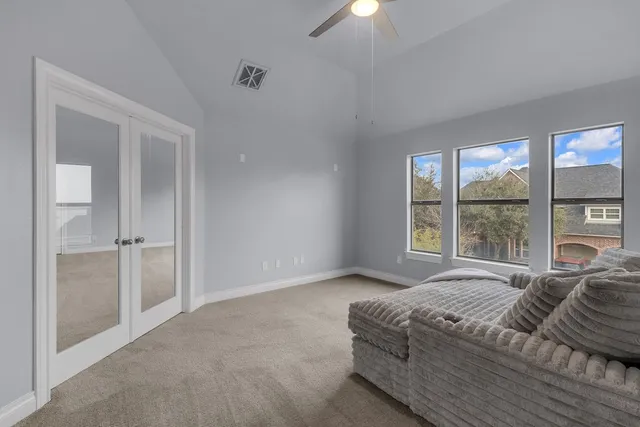 a view of a livingroom with a furniture ceiling fan and window