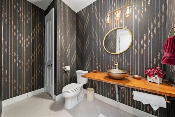 a bathroom with a toilet a sink and a mirror