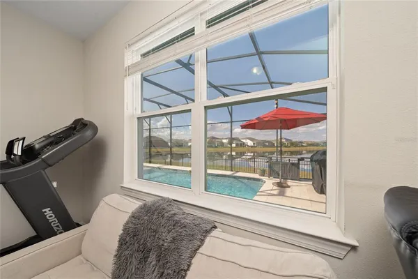 a bedroom with a bed and glass window