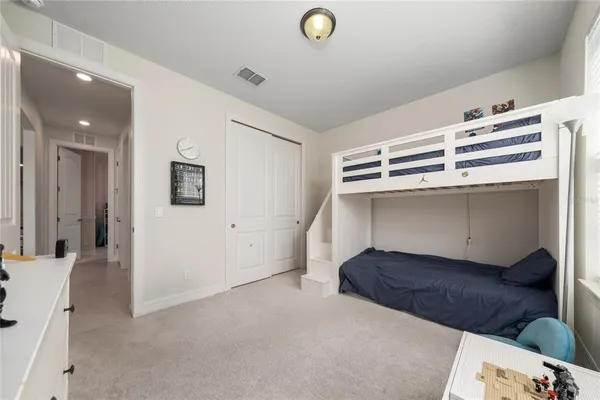 a bedroom with a bed and a view of kitchen