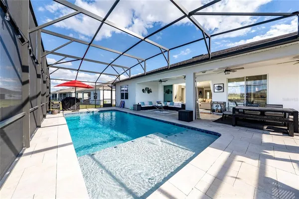 a view of swimming pool with sitting area