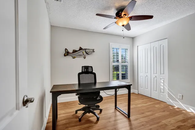a living room with furniture a window and a ceiling fan