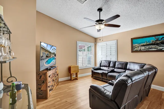 a kitchen view with stainless steel appliances a sink a stove a refrigerator and cabinets