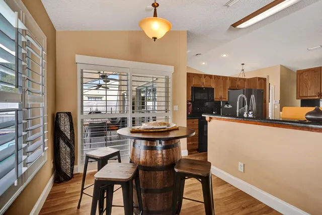 a kitchen with stainless steel appliances granite countertop a sink stove and cabinets