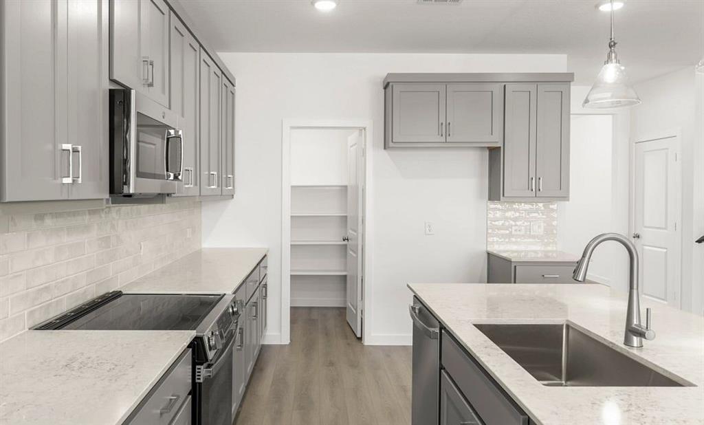 1008 Colgate Circle Princeton, TX 75407 - Photo 13 of 29 a kitchen with granite countertop a sink a stove and refrigerator