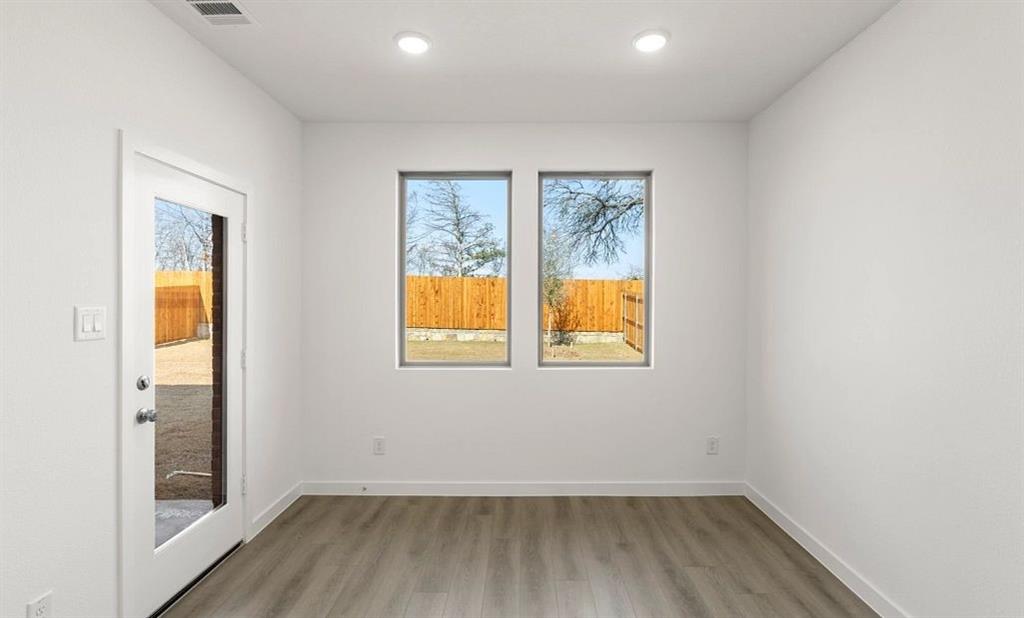 1008 Colgate Circle Princeton, TX 75407 - Photo 14 of 29 a view of an empty room with wooden floor and a window