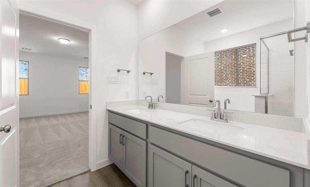 1008 Colgate Circle Princeton, TX 75407 - Photo 21 of 29 a bathroom with a sink double vanity and a mirror