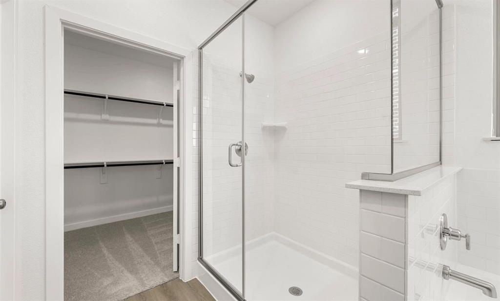 1008 Colgate Circle Princeton, TX 75407 - Photo 22 of 29 a bathroom with a glass shower door