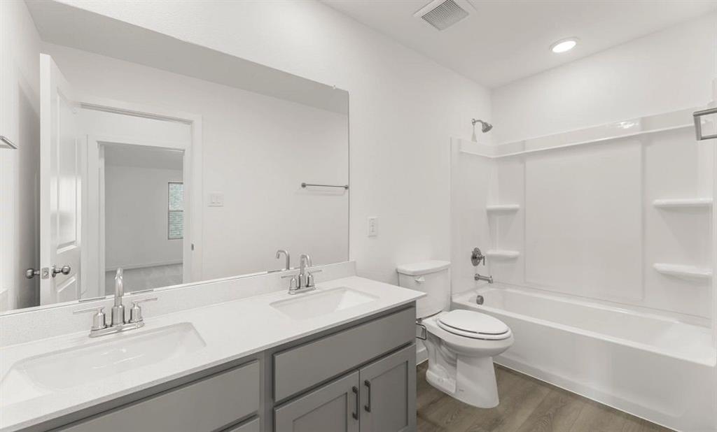 1008 Colgate Circle Princeton, TX 75407 - Photo 25 of 29 a bathroom with a double vanity sink toilet and shower