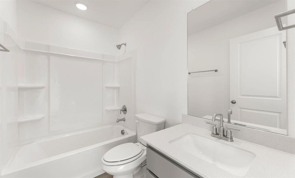 1008 Colgate Circle Princeton, TX 75407 - Photo 29 of 29 a bathroom with a bathtub shower sink vanity mirror and toilet