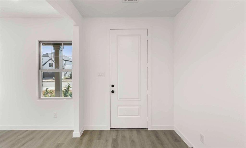 1008 Colgate Circle Princeton, TX 75407 - Photo 8 of 29 a view of an empty room with wooden floor and closet