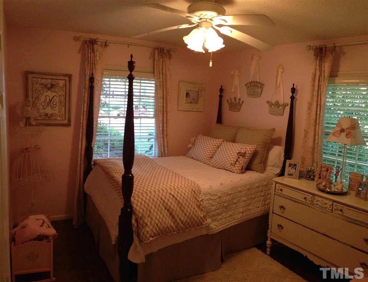 2109 Hillock Drive Raleigh, NC 27612 - Photo 12 of 23 a bedroom with a bed and a chandelier