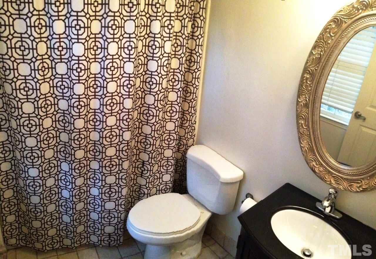 2109 Hillock Drive Raleigh, NC 27612 - Photo 15 of 23 a bathroom with a toilet and a mirror