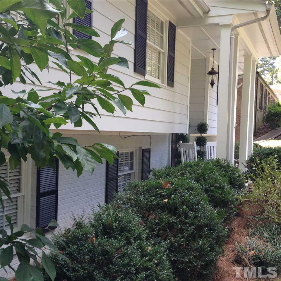 2109 Hillock Drive Raleigh, NC 27612 - Photo 3 of 23 a view of a house with a plants and a tree
