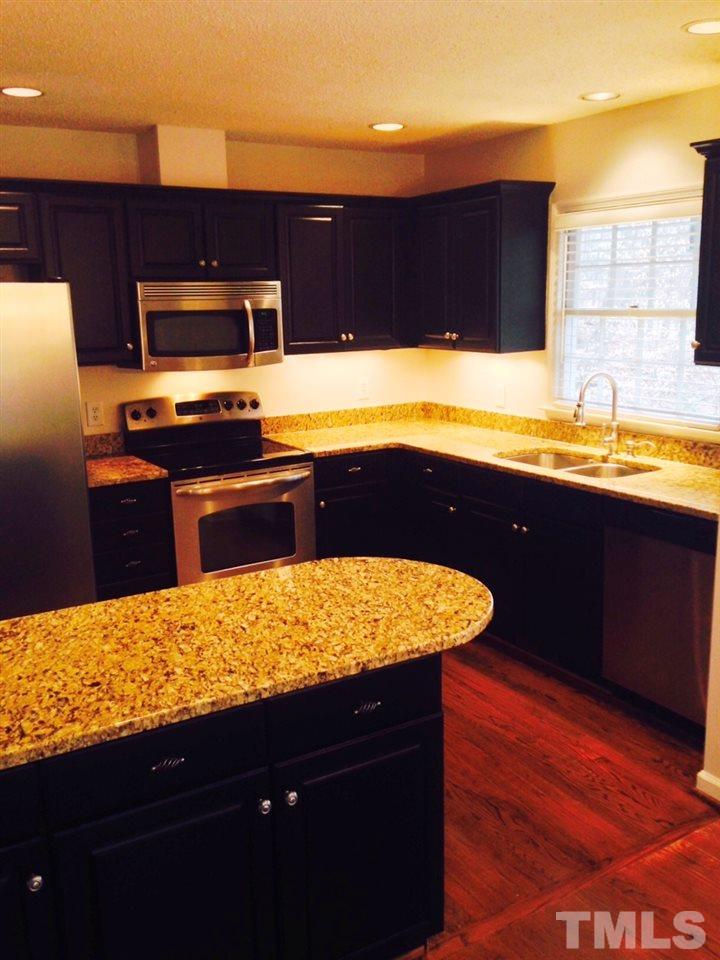 2109 Hillock Drive Raleigh, NC 27612 - Photo 4 of 23 a kitchen with a sink stove and microwave