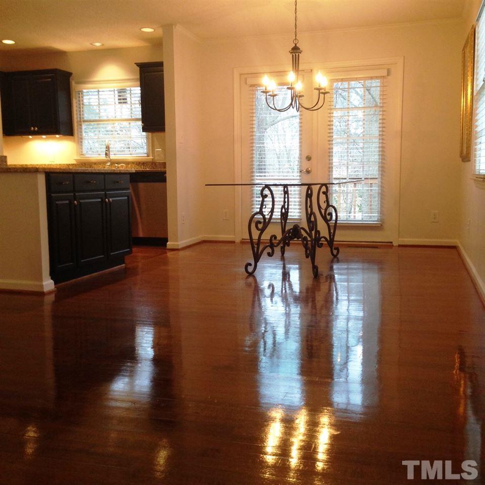 2109 Hillock Drive Raleigh, NC 27612 - Photo 5 of 23 a view of a living room and kitchen with furniture wooden floor
