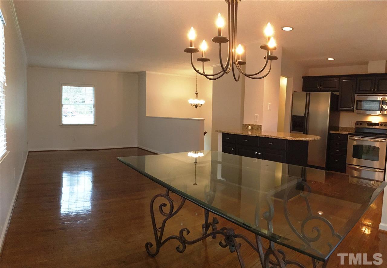 2109 Hillock Drive Raleigh, NC 27612 - Photo 6 of 23 a kitchen with granite countertop a stove a sink a counter space and cabinets