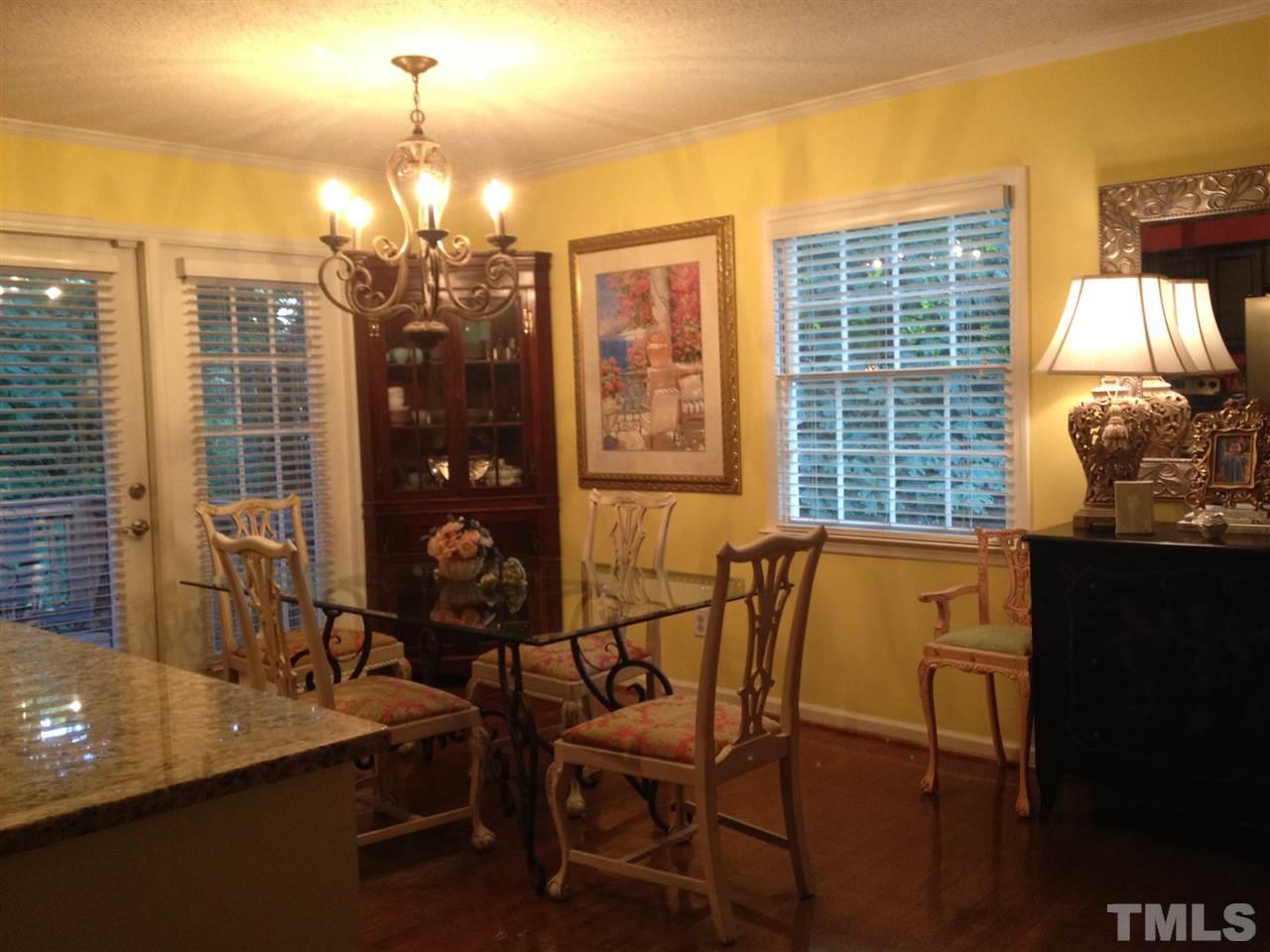 2109 Hillock Drive Raleigh, NC 27612 - Photo 10 of 23 a view of a dining room with furniture and chandelier