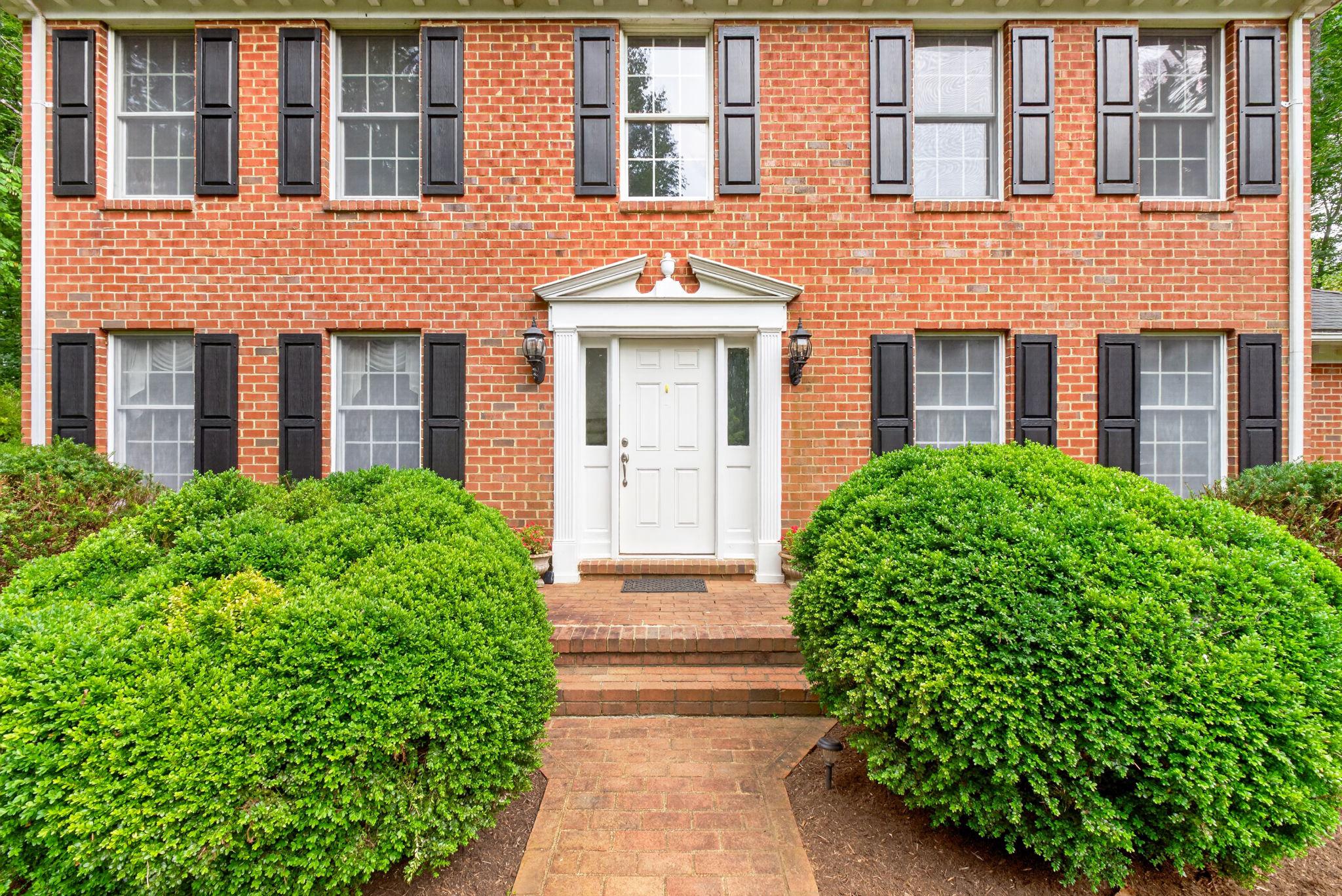 7501 Moormont Road Rapidan, VA 22733 - Photo 7 of 76 Charming brick facade with lush greenery.