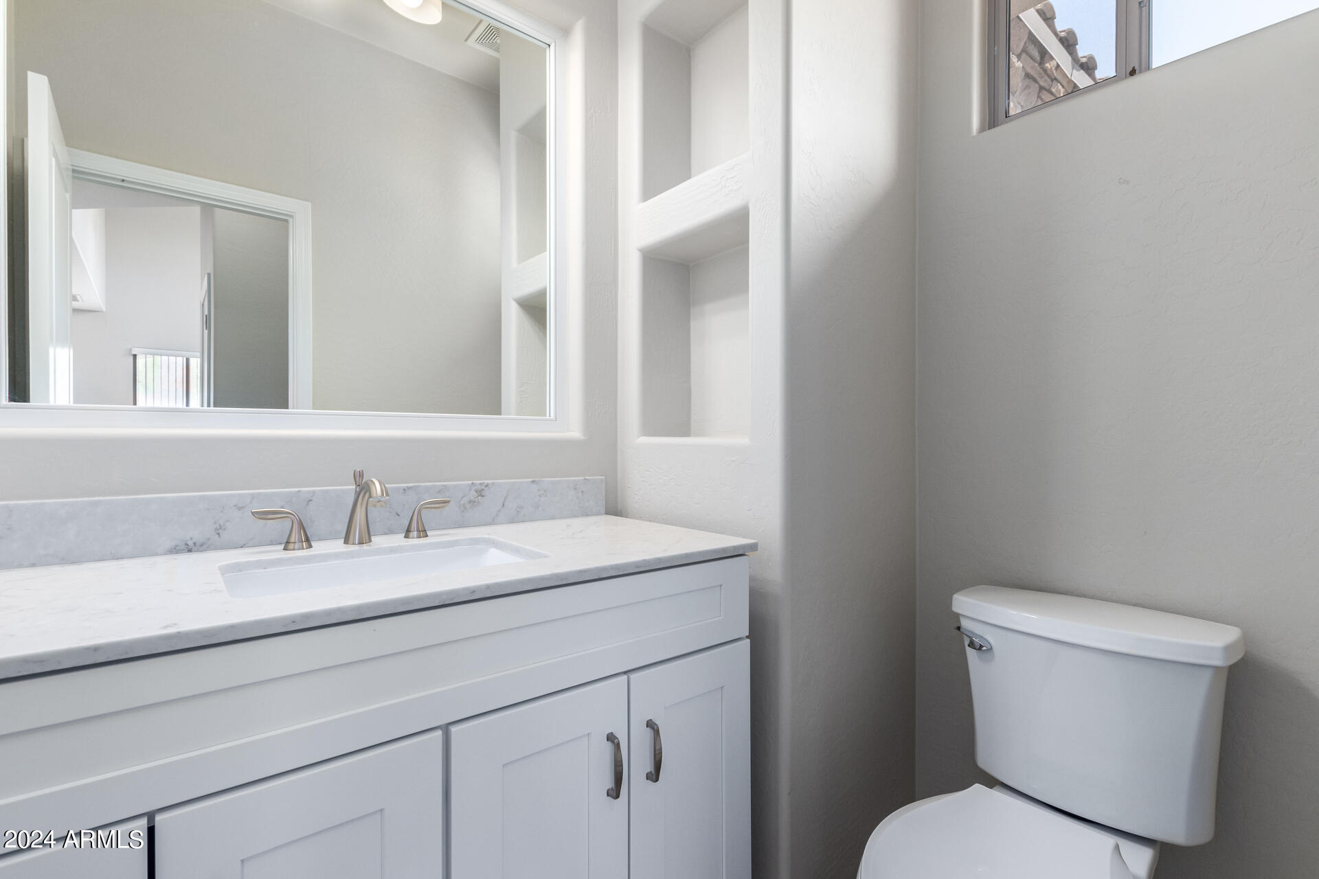 19475 North Grayhawk Drive, Unit 1100 Scottsdale, AZ 85255 - Photo 16 of 54 a bathroom with a toilet sink and mirror