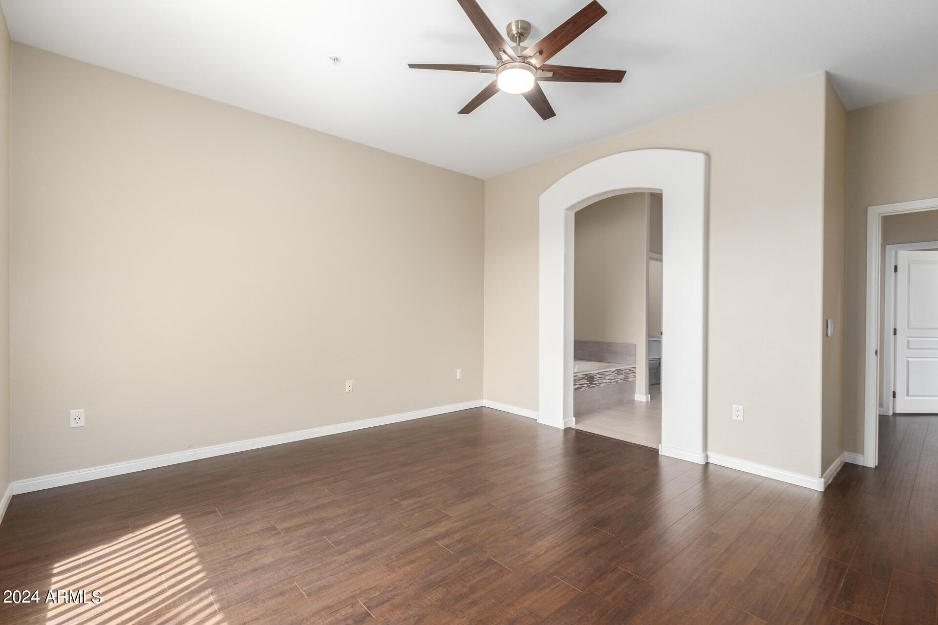 19475 North Grayhawk Drive, Unit 1100 Scottsdale, AZ 85255 - Photo 20 of 54 a view of an empty room with wooden floor and a ceiling fan