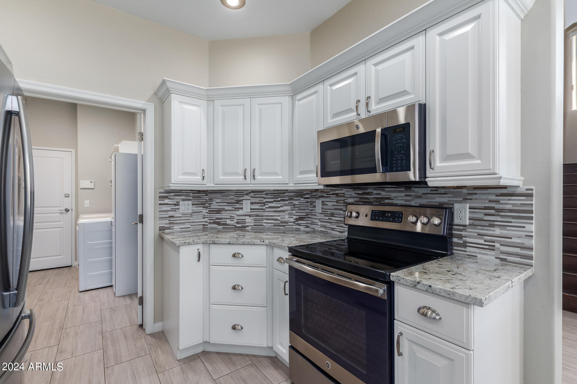 19475 North Grayhawk Drive, Unit 1100 Scottsdale, AZ 85255 - Photo 2 of 54 a kitchen with appliances a sink and cabinets
