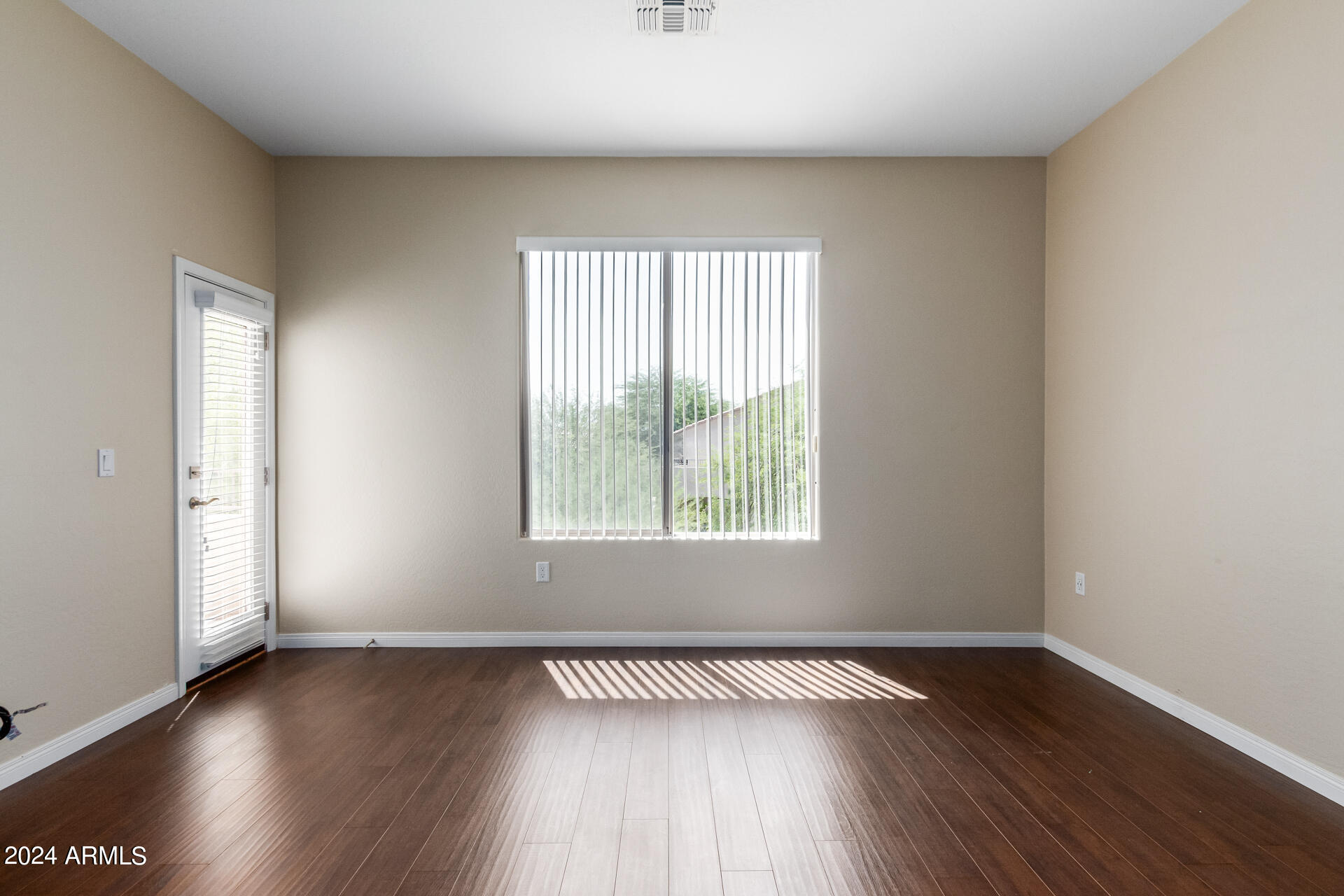 19475 North Grayhawk Drive, Unit 1100 Scottsdale, AZ 85255 - Photo 21 of 54 an empty room with wooden floor and windows