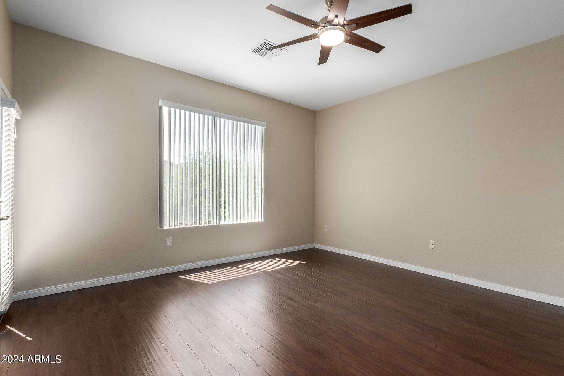 19475 North Grayhawk Drive, Unit 1100 Scottsdale, AZ 85255 - Photo 22 of 54 a view of an empty room with wooden floor and a window