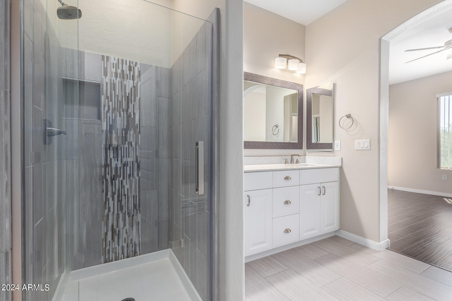 19475 North Grayhawk Drive, Unit 1100 Scottsdale, AZ 85255 - Photo 26 of 54 a bathroom with a double vanity sink a toilet a mirror and shower