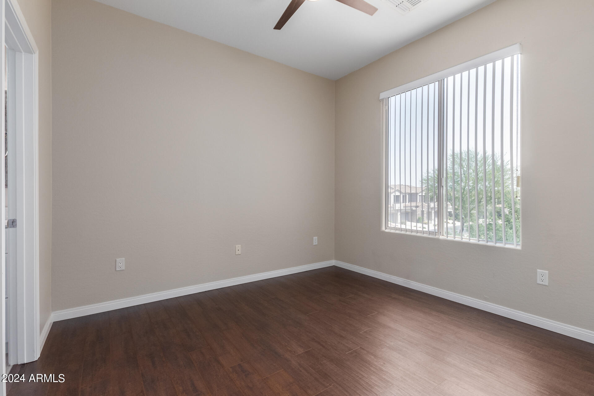 19475 North Grayhawk Drive, Unit 1100 Scottsdale, AZ 85255 - Photo 29 of 54 an empty room with wooden floor and windows