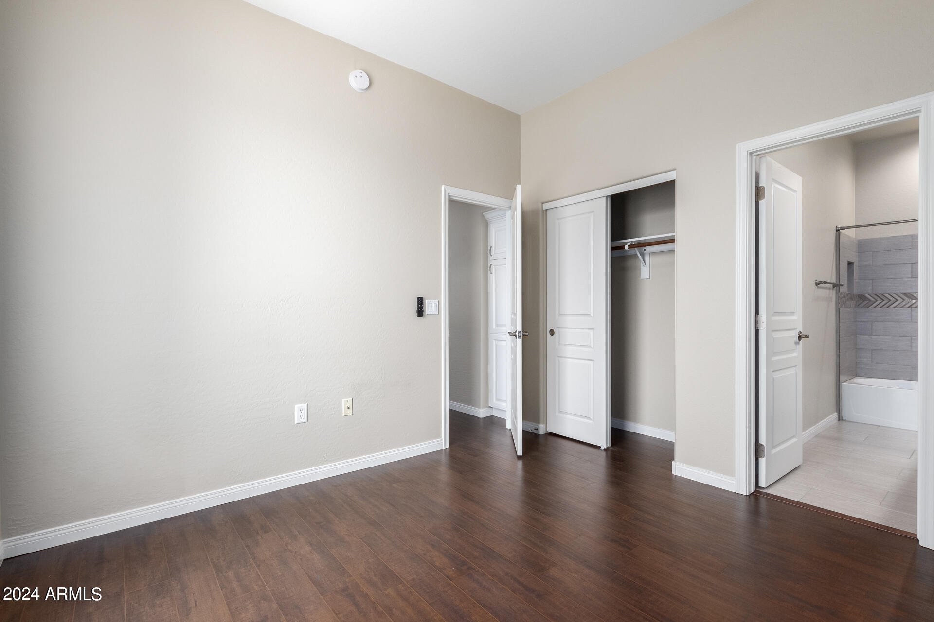 19475 North Grayhawk Drive, Unit 1100 Scottsdale, AZ 85255 - Photo 30 of 54 a view of an empty room with wooden floor and a bathroom