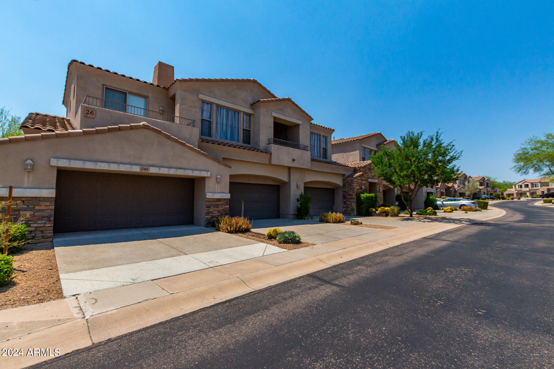 19475 North Grayhawk Drive, Unit 1100 Scottsdale, AZ 85255 - Photo 39 of 54 a front view of a house with a yard