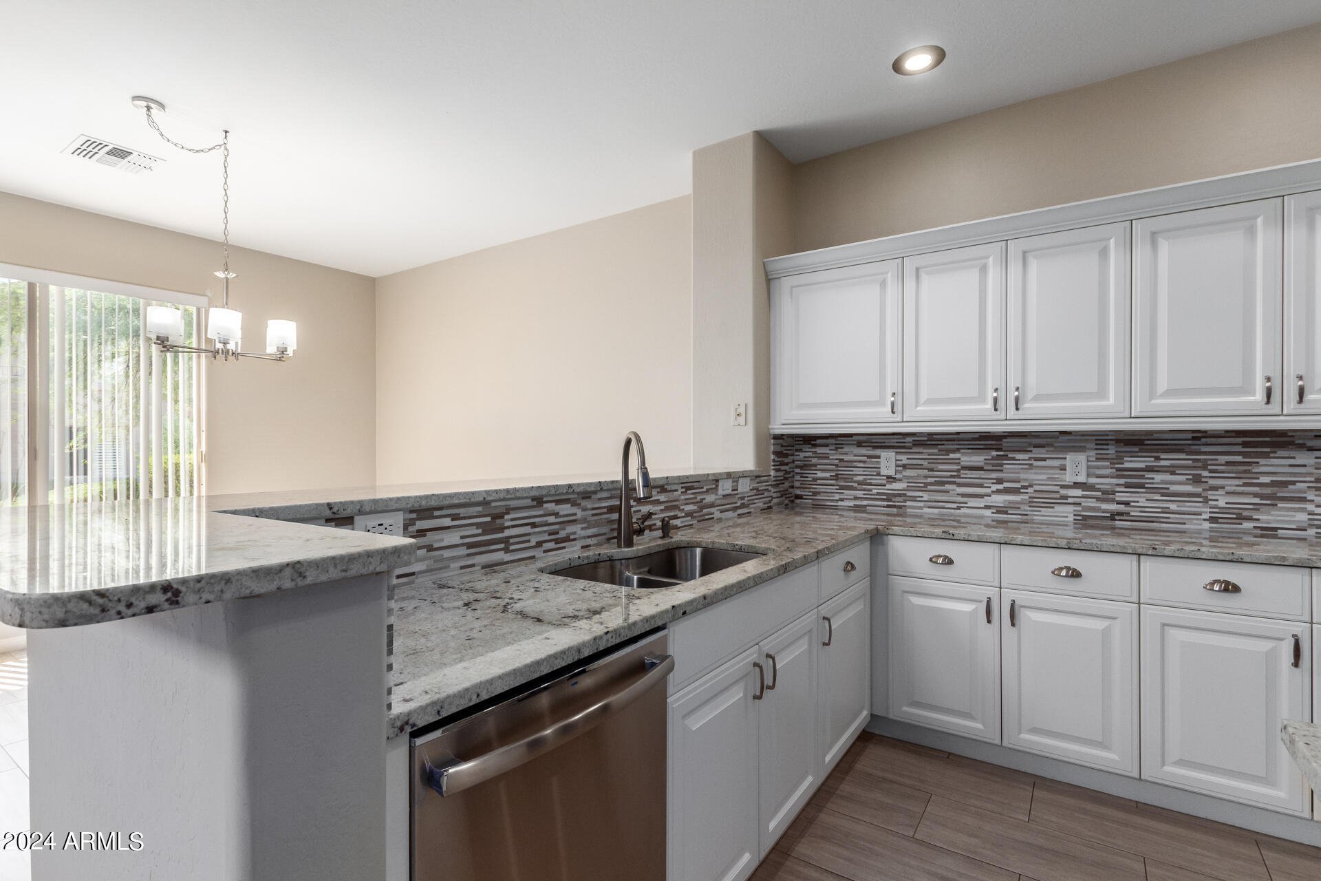 19475 North Grayhawk Drive, Unit 1100 Scottsdale, AZ 85255 - Photo 4 of 54 a kitchen with granite countertop a sink and cabinets