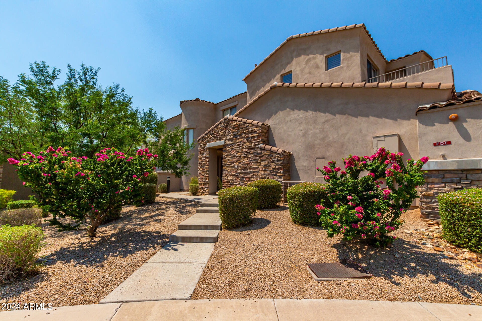 19475 North Grayhawk Drive, Unit 1100 Scottsdale, AZ 85255 - Photo 40 of 54 a front view of a house with a yard