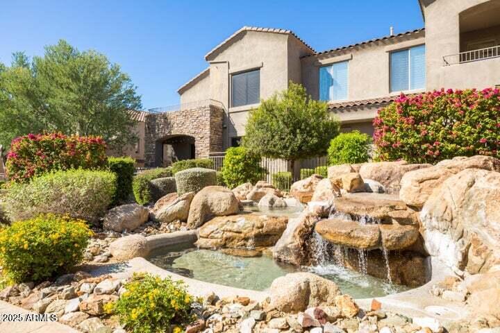 19475 North Grayhawk Drive, Unit 1100 Scottsdale, AZ 85255 - Photo 46 of 54 a front view of a house with a yard