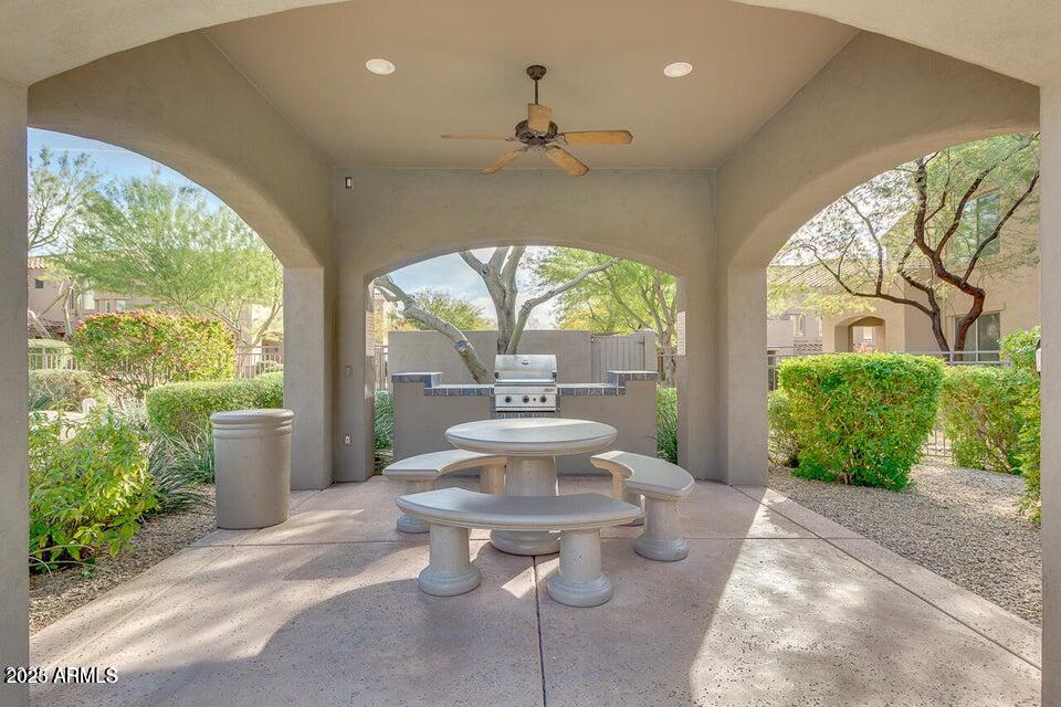 19475 North Grayhawk Drive, Unit 1100 Scottsdale, AZ 85255 - Photo 47 of 54 a view of a patio with table and chairs potted plants with large tree