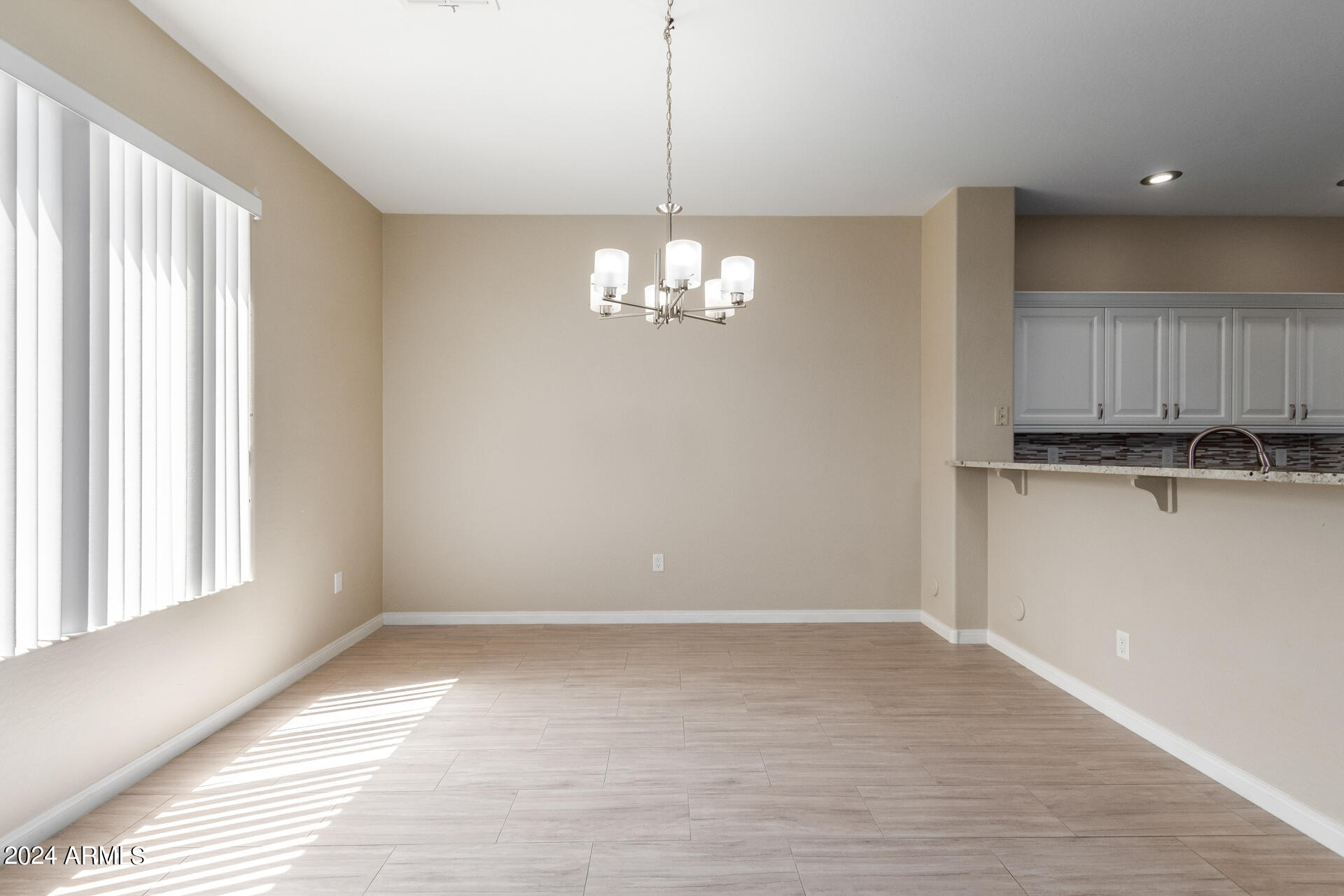 19475 North Grayhawk Drive, Unit 1100 Scottsdale, AZ 85255 - Photo 6 of 54 a view of a kitchen with windows and chandelier