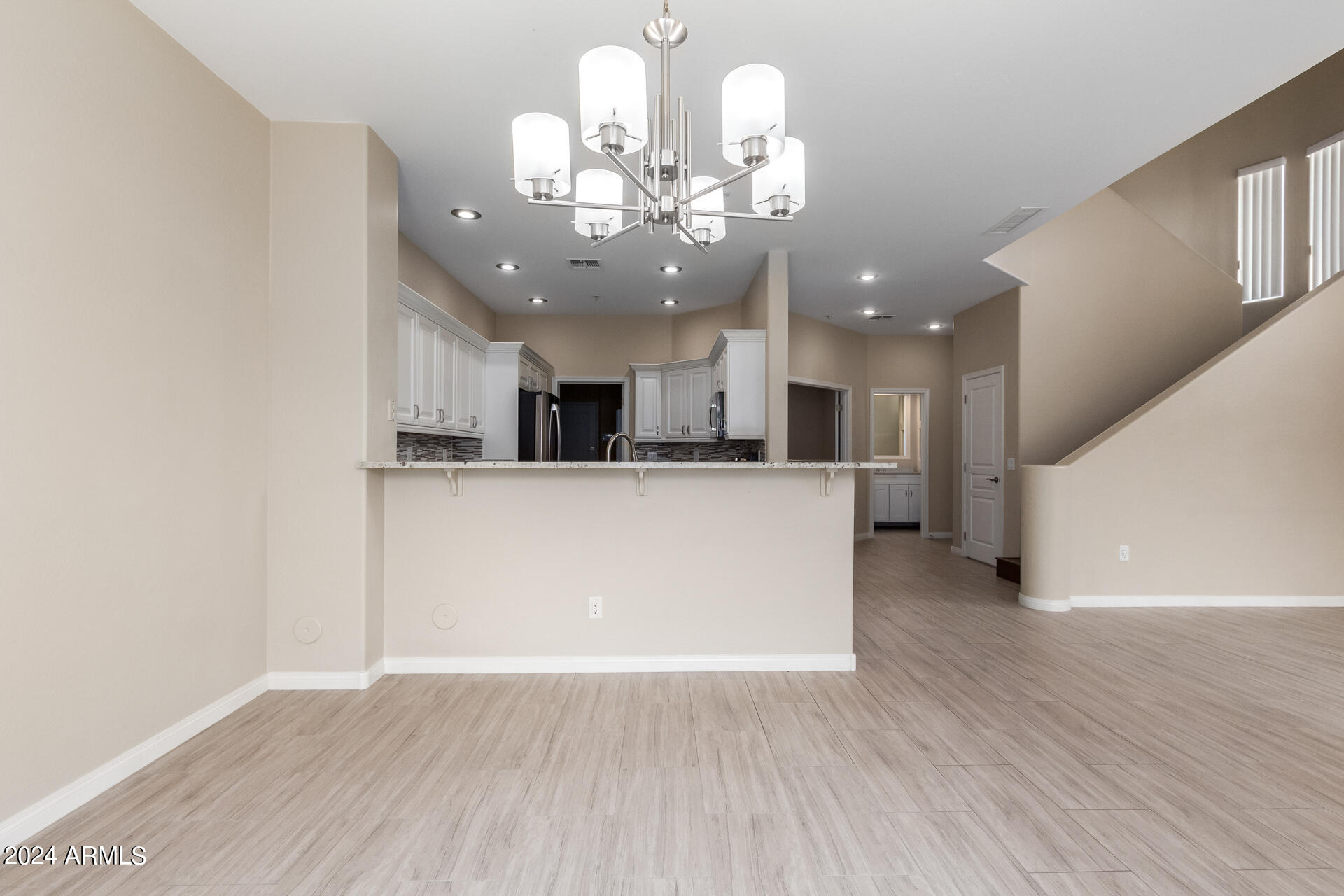 19475 North Grayhawk Drive, Unit 1100 Scottsdale, AZ 85255 - Photo 7 of 54 a view of a kitchen with kitchen island and stainless steel appliances