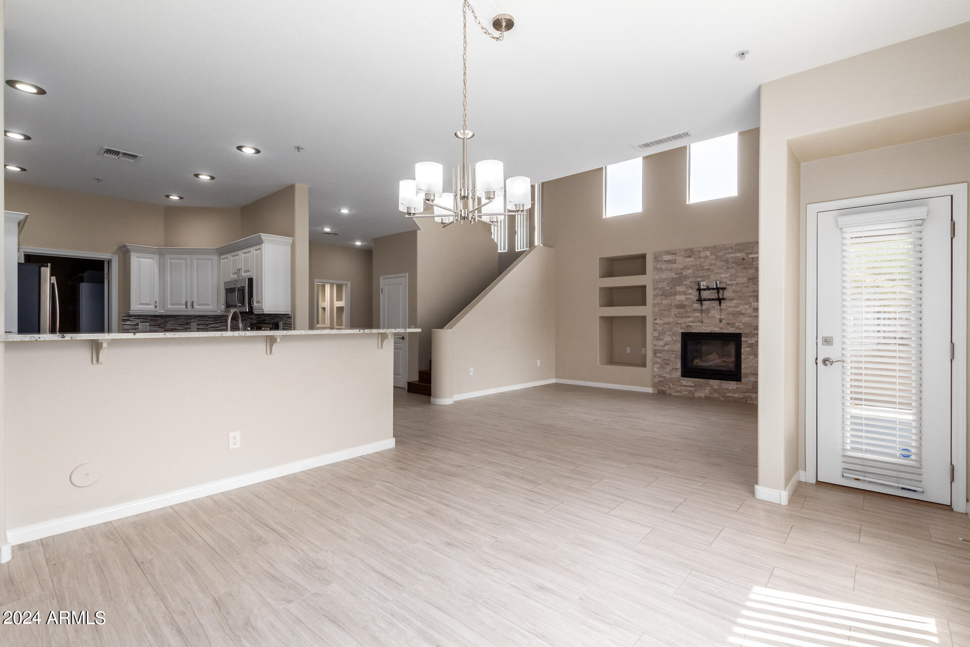 19475 North Grayhawk Drive, Unit 1100 Scottsdale, AZ 85255 - Photo 8 of 54 a view of a kitchen with a sink and a fireplace