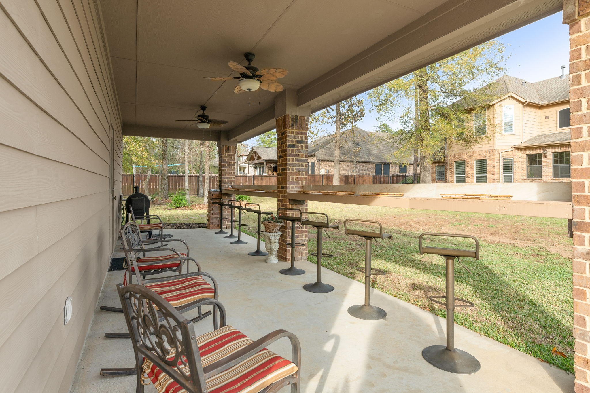28503 Riverside Crest Lane Houston, TX 77336 - Photo 44 of 50 Crank up the grill and enjoy family gatherings on this nifty covered patio and handy serving bench!