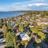 a living room with furniture a large window and a table