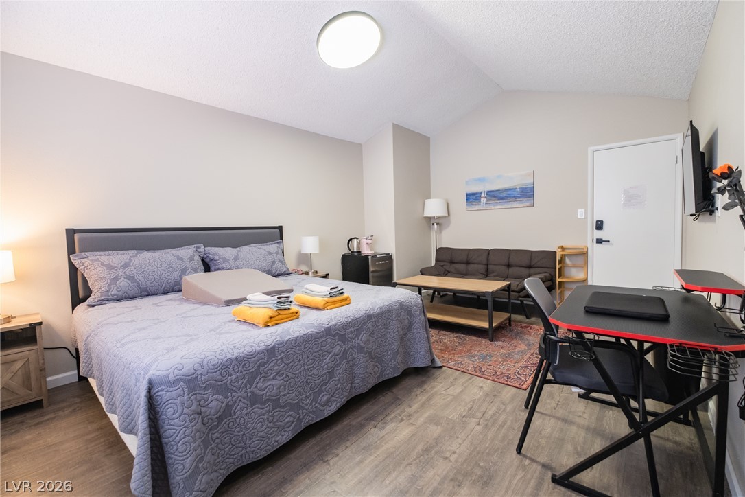 6356 West Viking Road Las Vegas, NV 89103 - Photo 34 of 51 Vaulted ceilings and wood-style flooring enhance this versatile bedroom space.