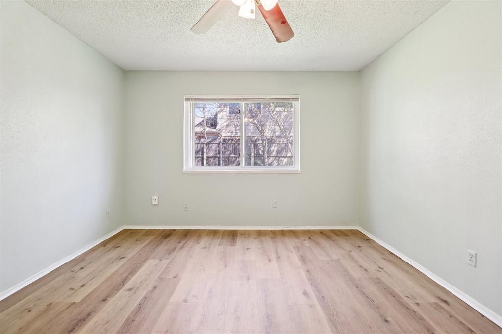 3216 Red Oak Lane Bedford, TX 76021 - Photo 21 of 40 an empty room with wooden floor and windows