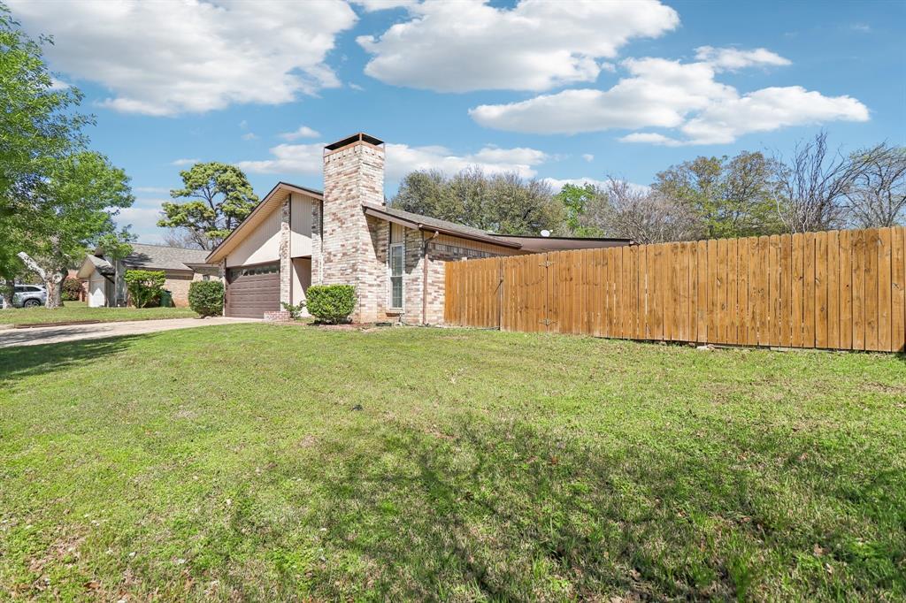 3216 Red Oak Lane Bedford, TX 76021 - Photo 3 of 40 a front view of a house with garden