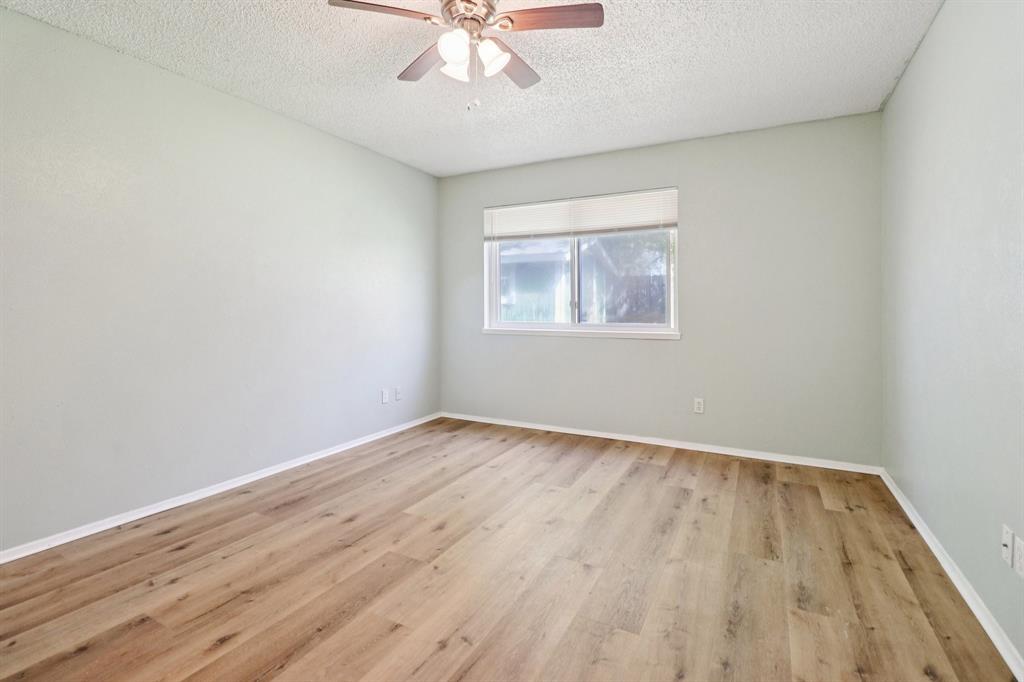 3216 Red Oak Lane Bedford, TX 76021 - Photo 32 of 40 wooden floor in an empty room with a window