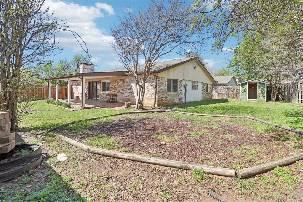 3216 Red Oak Lane Bedford, TX 76021 - Photo 39 of 40 a front view of a house with a yard and trees