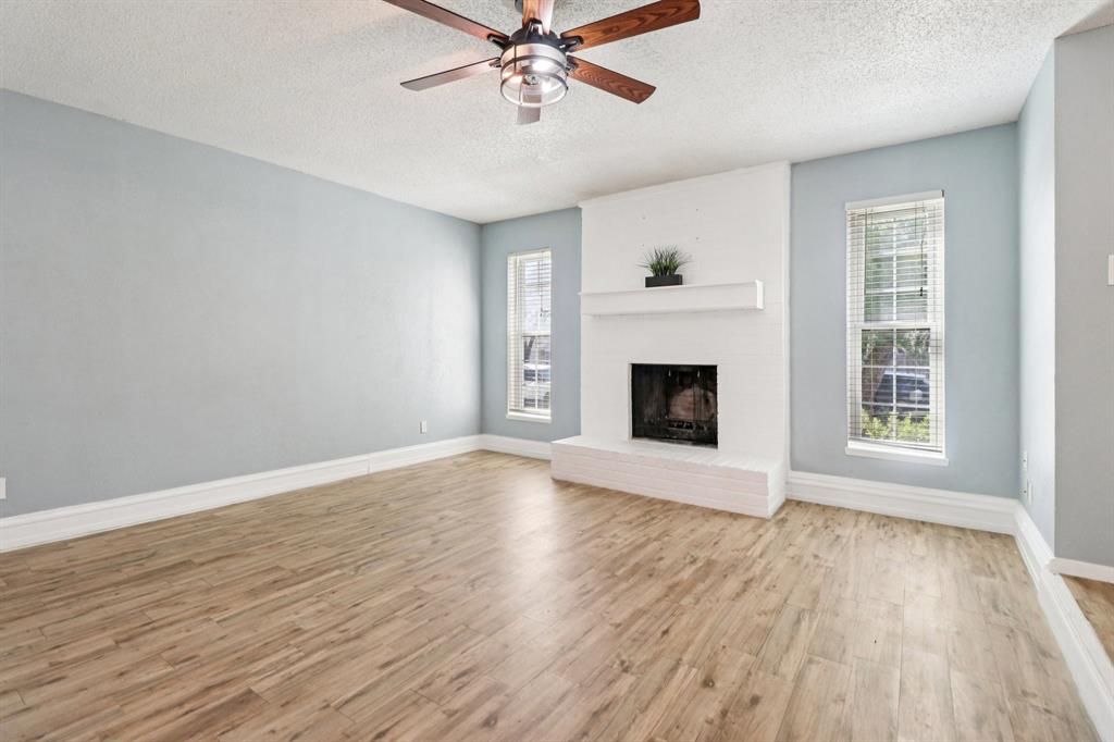 3216 Red Oak Lane Bedford, TX 76021 - Photo 6 of 40 a view of an empty room with wooden floor and a window