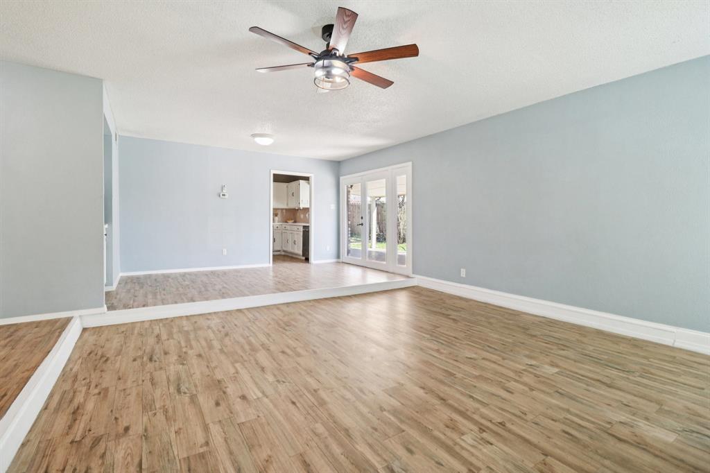 3216 Red Oak Lane Bedford, TX 76021 - Photo 8 of 40 wooden floor in an empty room with a window