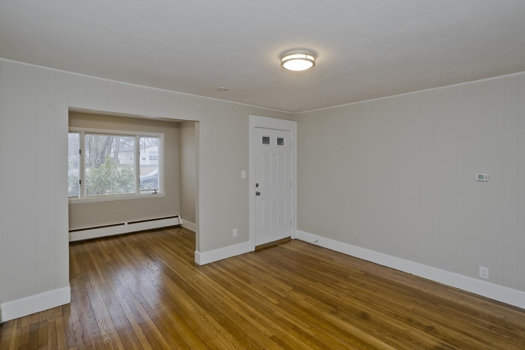 177 Marion Street Chicopee, MA 01013 - Photo 20 of 36 a view of an empty room with wooden floor and a window