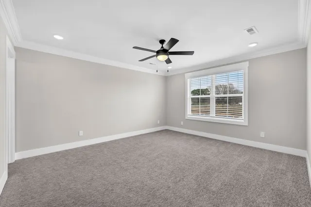 a view of a livingroom with a ceiling fan and window